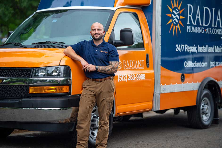 Radiant technician leaning against the Radiant Truck