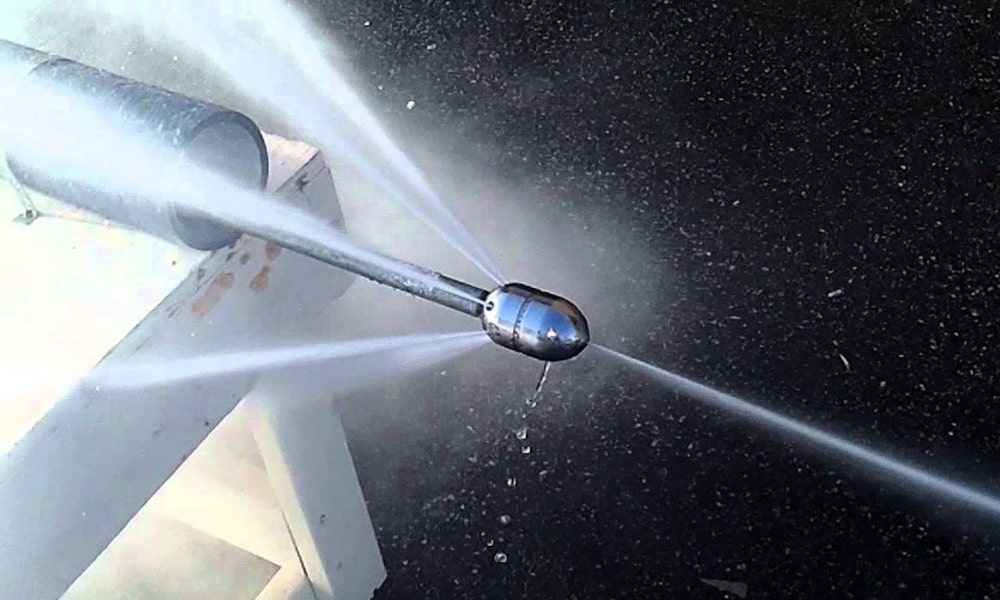 A photograph of a hydro jet expelling water