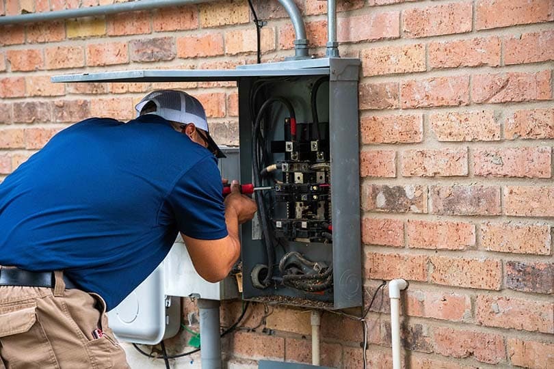 A Radiant technician working on an electrical panel repair.