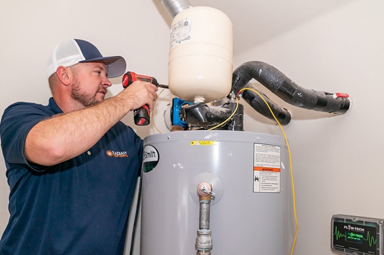 Radiant technician inspecting water heater