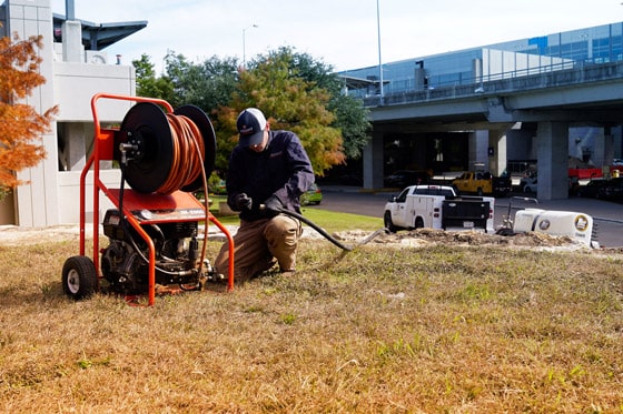 Radiant Technician sets up hose for water jetting