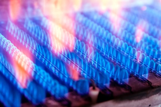 an up close image of gas flame burning on a stove