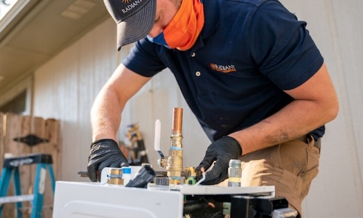A Radiant technician working on a tankless