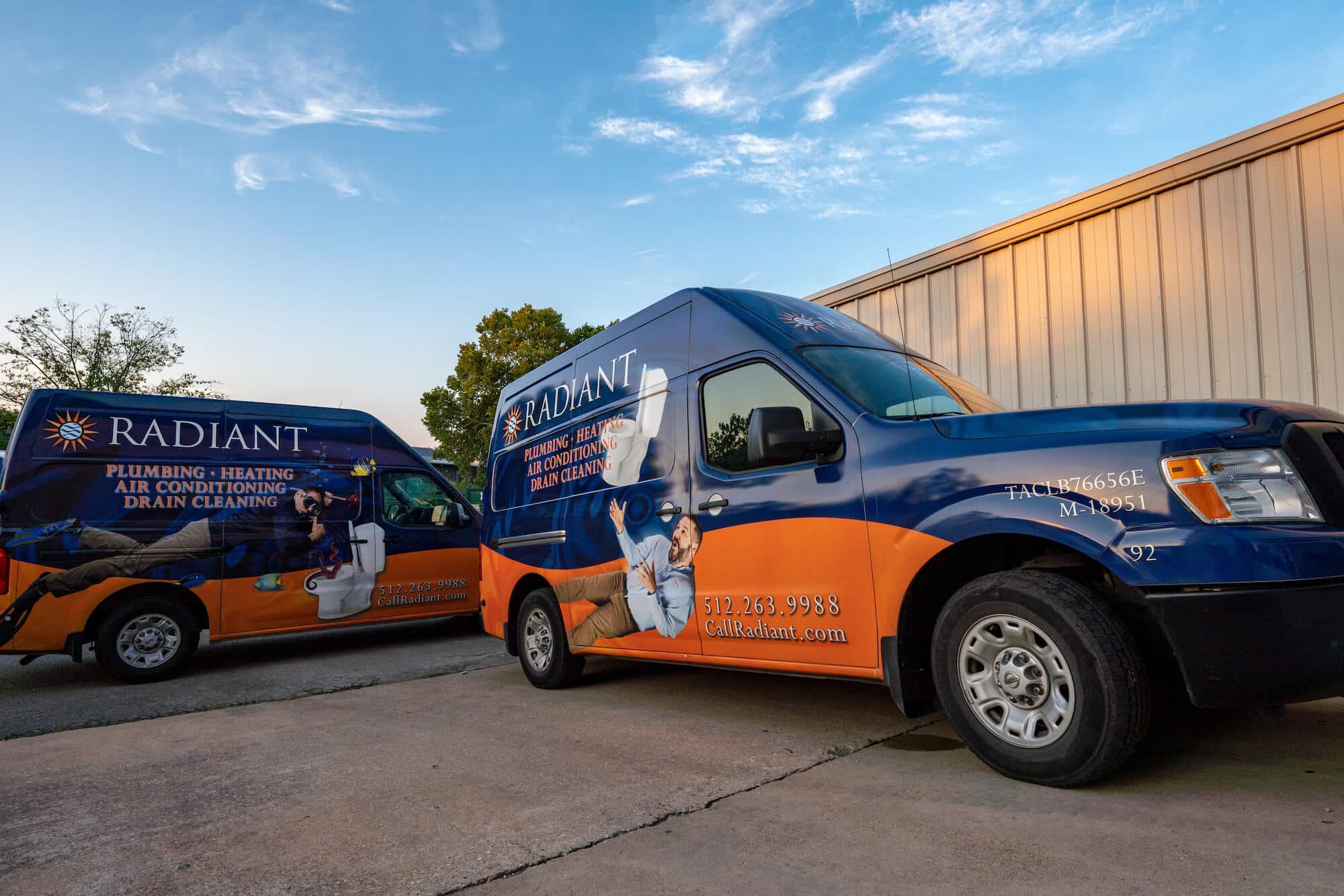 Two Radiant Plumbing & Air Conditioning Trucks parked