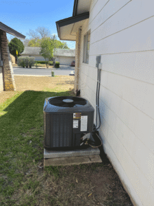 Outdoor AC condenser installed on pad in San Antonio TX during system replacement