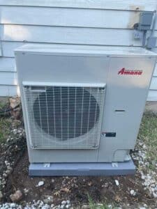A new Amana HVAC system installed outside on a cement slab
