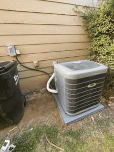 Carrier air conditioner installed on pad beside home in Austin TX during HVAC replacement