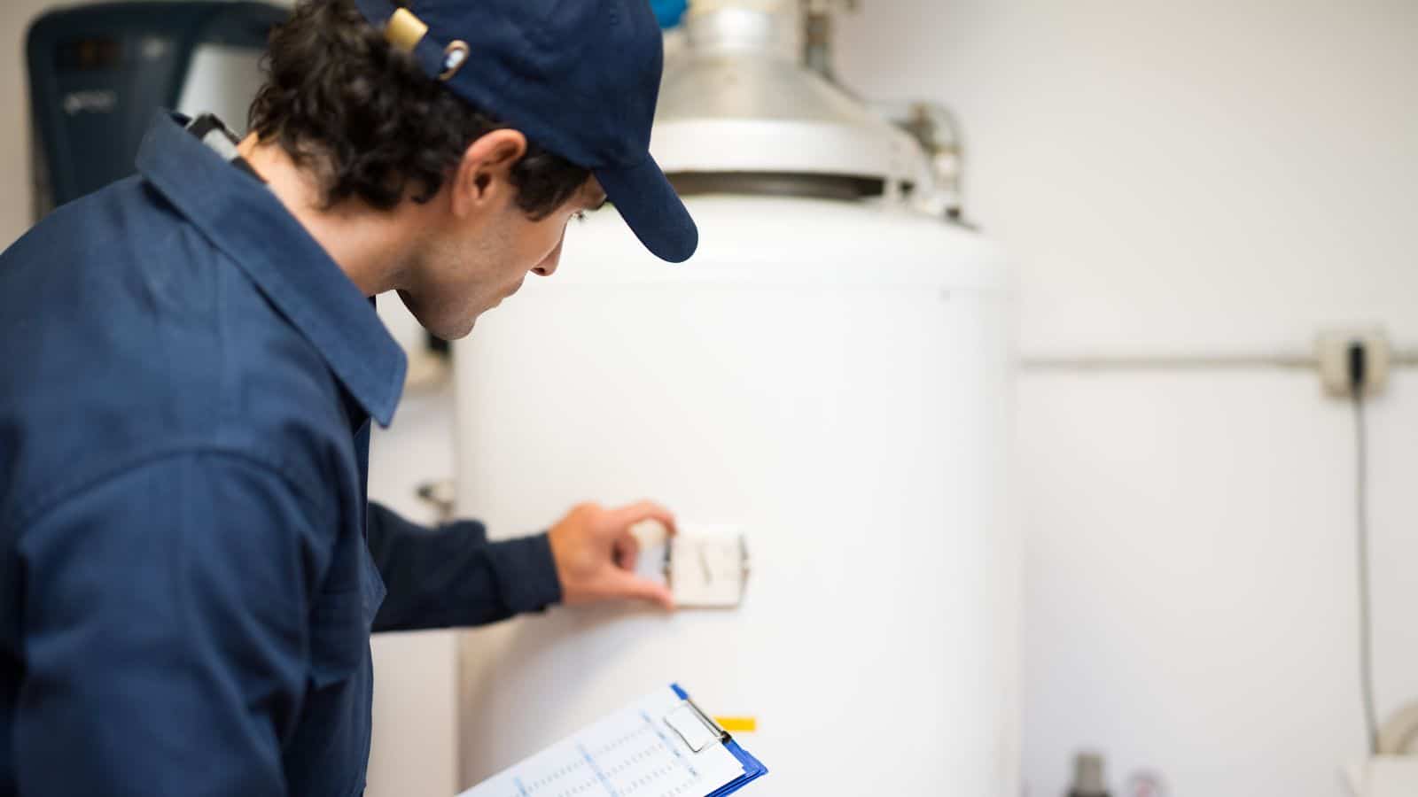 A plumber checking the water heater in a home