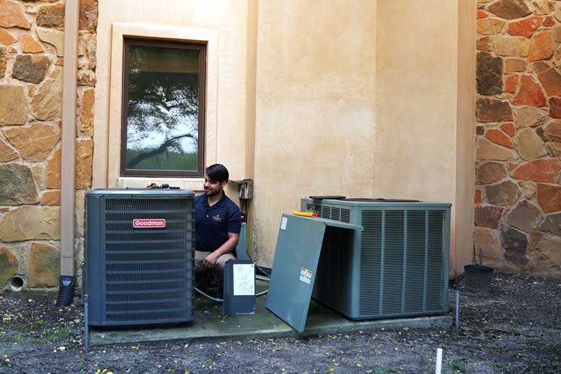 A Radiant HVAC technician repairing an AC