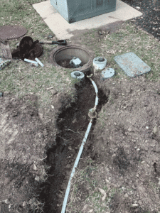 Trench work exposing main water line for new shutoff valve and pressure control installation