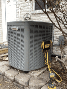 Lennox heat pump condenser installed outside home in Boerne TX during HVAC system replacement