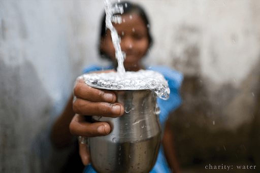 girl holding cup of water