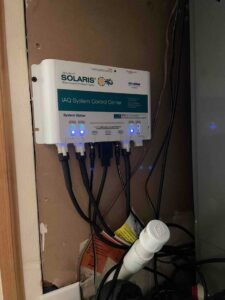 Solaris whole-home air quality control center mounted and operating with indicator lights
