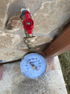 Water pressure test gauge connected to outdoor spigot in Spring Branch TX