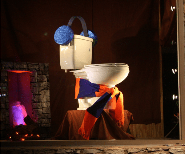 Toilet display at Radiant Austin office with earmuffs and a scarf