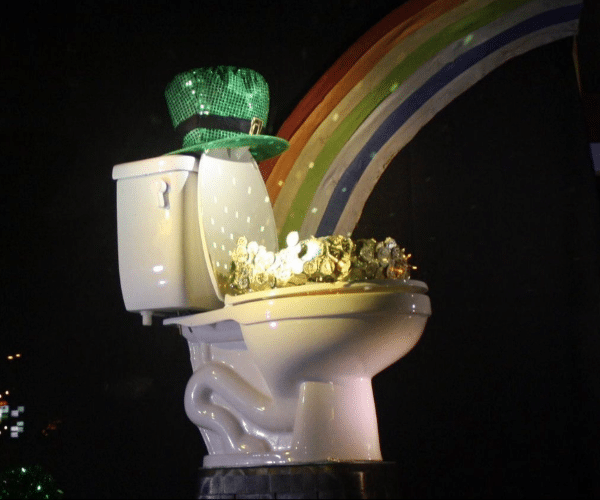 Toilet display at Radiant Austin office with a green sparkly leprechaun hat, full of "gold", and a rainbow