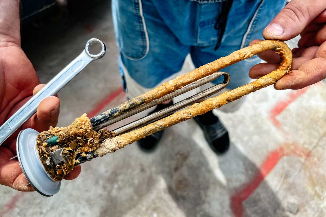 The dirty sediment rod from a water heater
